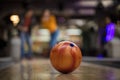 Young couple having fun in bowling alley. Focus is on bowler Royalty Free Stock Photo