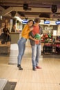 Young couple having fun in bowling alley. Royalty Free Stock Photo