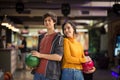 Young couple having fun in bowling alley. Holding a bowler Royalty Free Stock Photo