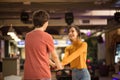 Young couple having fun in bowling alley.  Holding hands. Royalty Free Stock Photo