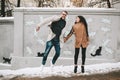 Young couple having fun on the city street in winter Royalty Free Stock Photo