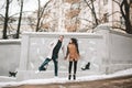 Young couple having fun on the city street in winter Royalty Free Stock Photo