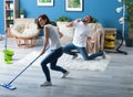 Young couple having fun while cleaning their flat Royalty Free Stock Photo