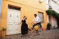 Young couple having fun while cycling. Love story in the old city of Italy Royalty Free Stock Photo