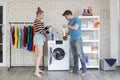 Young Couple having fun while doing spring cleaning together in their house. Couple at home having fun while doing household chore Royalty Free Stock Photo