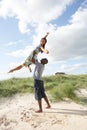 Young Couple Having Fun In Dunes By Beach Royalty Free Stock Photo