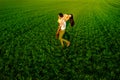 Young couple having fun on the green field in the spring or summer, general plan Royalty Free Stock Photo