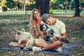 Young couple having fun with guitar during picnic in the park Royalty Free Stock Photo