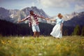 Young couple having fun holding hands on sunny day in green meadow. Joyful couple in nature. Fun, togetherness, lifestyle, nature Royalty Free Stock Photo