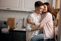 Young couple having fun in the kitchen room