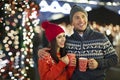 Couple drinking mulled wine at Christmas market Royalty Free Stock Photo