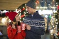 Couple drinking mulled wine at Christmas market Royalty Free Stock Photo