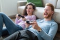Young couple having fun playing video games