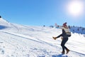 Young couple having fun on snow. Happy man at the mountain giving piggyback ride to his smiling girlfriend. Royalty Free Stock Photo