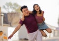 Young couple having fun on street. Man carrying his girlfriend Summer romance Royalty Free Stock Photo