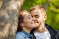 Young couple having fun, talking, flirting in a sunny park in springtime Royalty Free Stock Photo