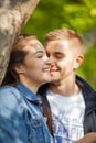 Young couple having fun, talking, flirting in a sunny park in springtime Royalty Free Stock Photo