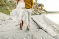 A young couple is having fun and walking on the sea coastline. Newlyweds looking at each other with tenderness. Romantic Royalty Free Stock Photo