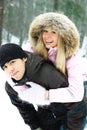 Young couple having fun in winter park Royalty Free Stock Photo