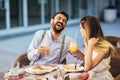 Young couple having good time in cafe restaurant. They are smiling and eating a pizza Royalty Free Stock Photo