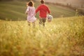 A young couple having a good time while running over a large meadow. Love, relationship, together, nature Royalty Free Stock Photo