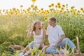 Young couple having picnic on sunflower field Royalty Free Stock Photo