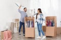 Young couple having pillow fight near wardrobe boxes Royalty Free Stock Photo