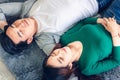 Young Couple Having Relaxing While Lying on Carpet at Their Home, Attractive Asian Couple Love are Relaxed Together on Living Room Royalty Free Stock Photo