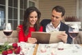 Young couple having romantic dinner in the restaurant holding menu concentrated Royalty Free Stock Photo