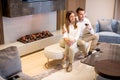 Young couple having a romantic evening with a glass of red wine at home in the contemporary living room Royalty Free Stock Photo