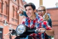 Young couple having scooter ride through Berlin Royalty Free Stock Photo