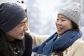 Young Couple Having a Snowball Fight