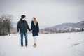 Young couple having a walk in snowy countryside