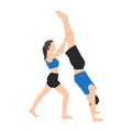 Young couple helping each other to practicing yoga. Woman helps a man doing handstand yoga exercise