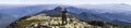 Young couple hike in Carpathian mountains. Man and woman standing on mountain top looking at beautiful landscape below. Wide panor Royalty Free Stock Photo