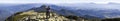 Young couple hike in Carpathian mountains. Man and woman standing on mountain top looking at beautiful landscape below. Wide panor Royalty Free Stock Photo