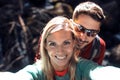 Young couple of hikers taking a selfie while standing in the forest Royalty Free Stock Photo