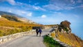 Young couple hiking in the beautiful Lavaux winery area near Chexbres, direction Montreux in Switzerland. Beautiful autumn colors