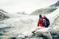 Young couple hiking in the swiss alps, taking a break Royalty Free Stock Photo