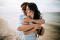 A young couple of hipsters hugging and kissing on a deserted beach. Summer trip Royalty Free Stock Photo