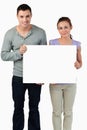 Young couple holding banner together Royalty Free Stock Photo