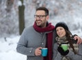 Man and woman with hot drink on snow Royalty Free Stock Photo