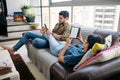 Young Couple Holding Ereader And Reading Ebook