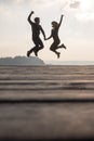 Young couple holding hands jumping in the air Royalty Free Stock Photo