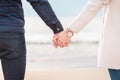 Young couple holding hands at sunset on beach. Romantic young couple enjoying sun, sunshine, Couple on spring vacation Royalty Free Stock Photo