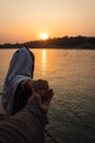 Young couple holding hands at sunset at ganges river bank from different angle