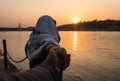 Young couple holding hands at sunset at ganges river bank from different angle