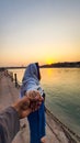 Young couple holding hands at sunset at ganges river bank from different angle image is taken at ganga river bank rishikesh