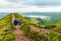 A young couple holding hands while walking towards the Grota do Inferno viewpoint at Sete Cidades on Sao Miguel Island, Azores Royalty Free Stock Photo