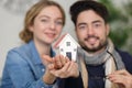 Young couple holding house model Royalty Free Stock Photo